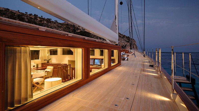 Comfortable sailing yacht side deck at dusk