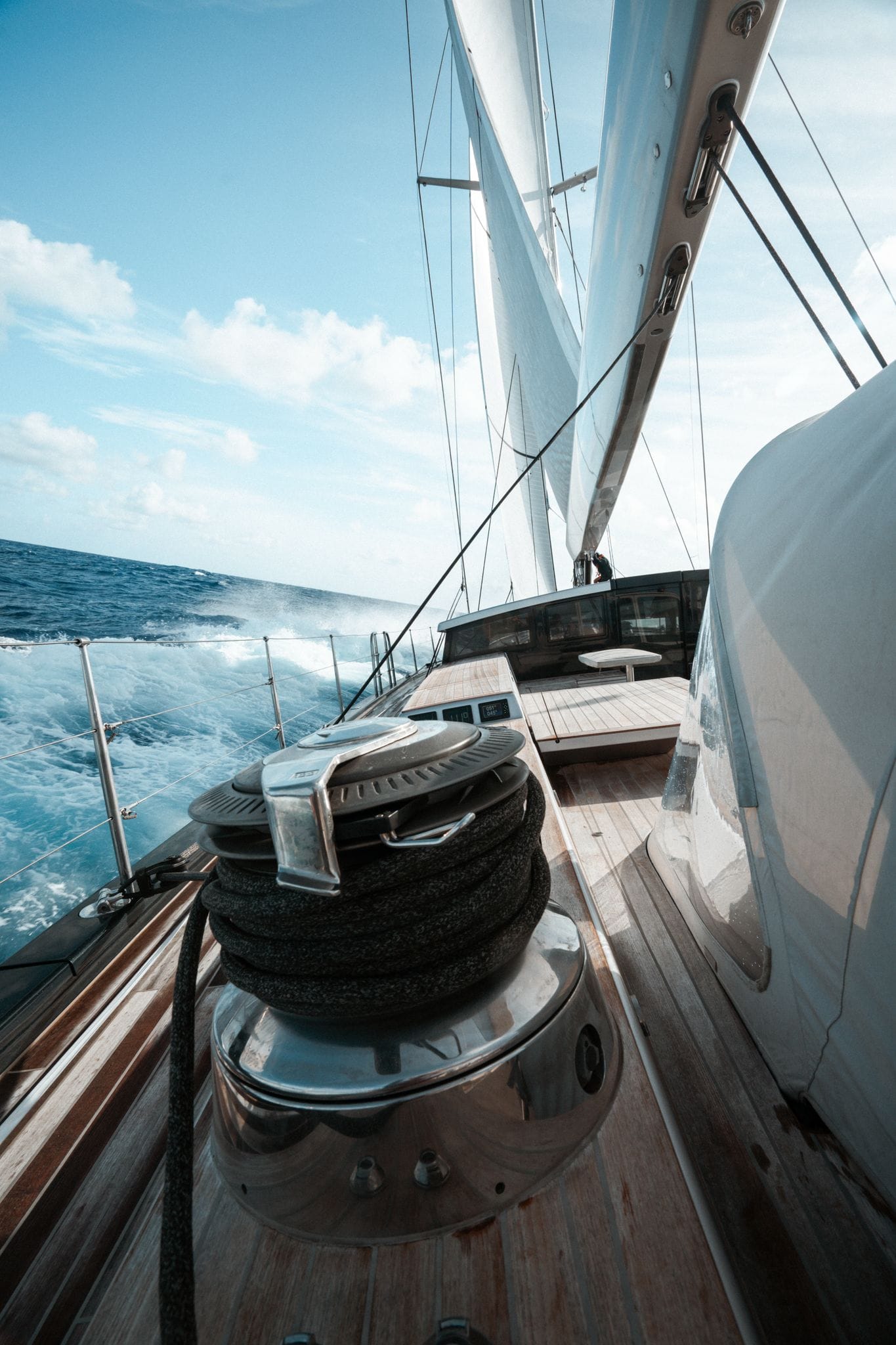 Performance sailing yacht underway viewed along the deck