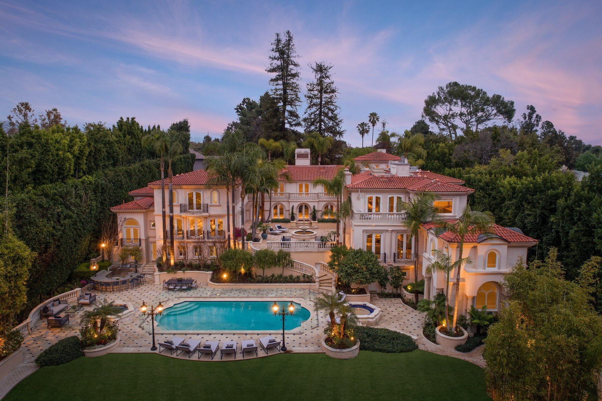 Grand private estate with a pool at dusk
